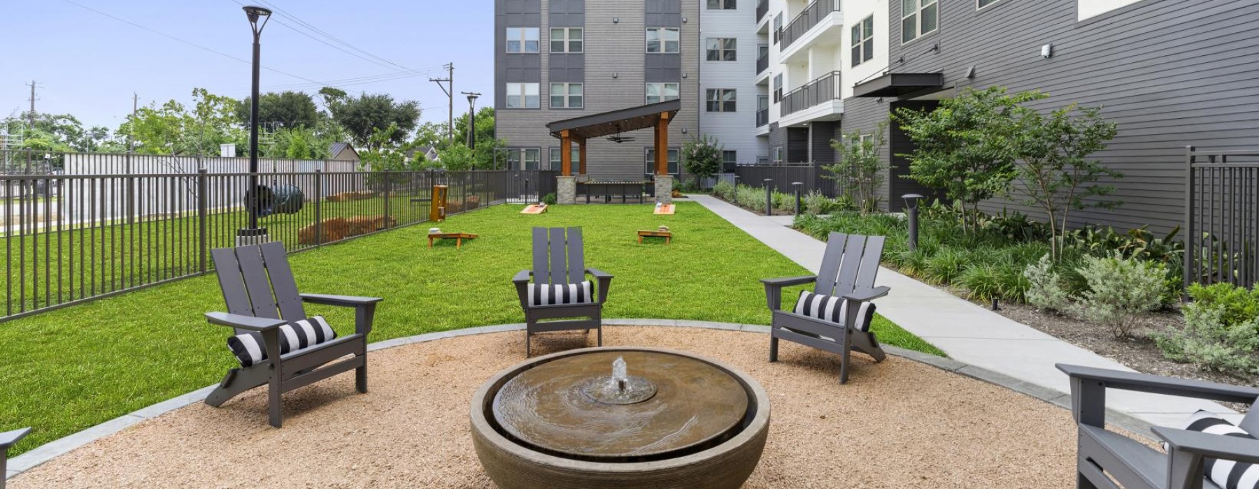 a fire pit with lounge chairs