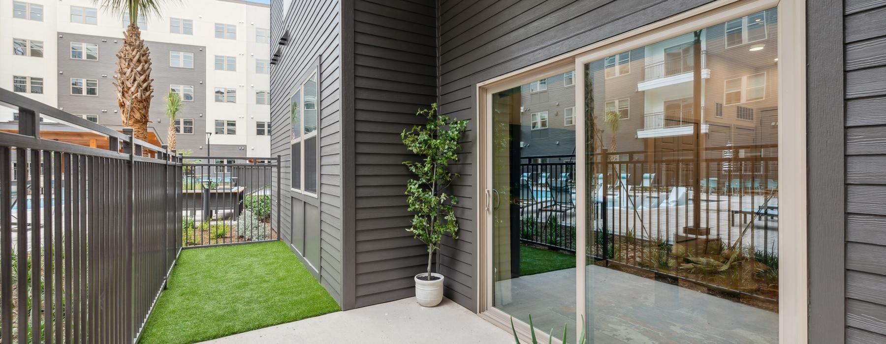 a patio with plants and grass